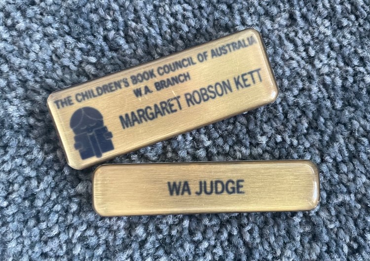 Metal badges with name of judge and CBCA logo